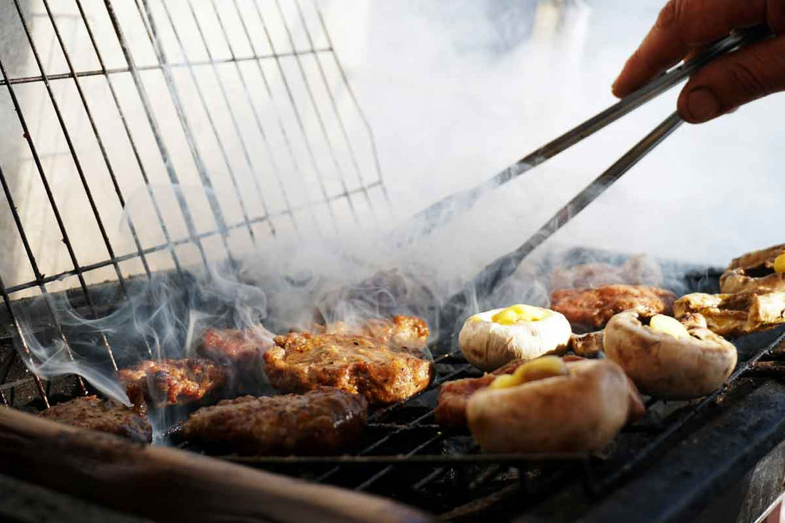 Food being cooked on the barbecue giving off a large amount of smoke.