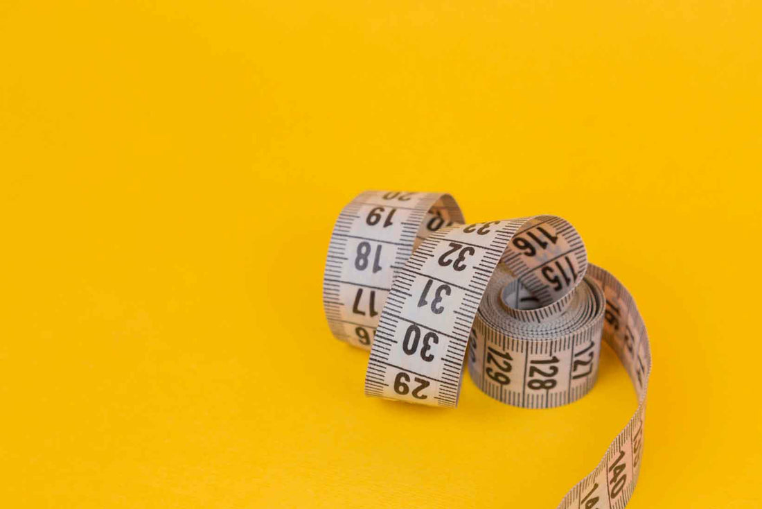 Measuring tape on a yellow background